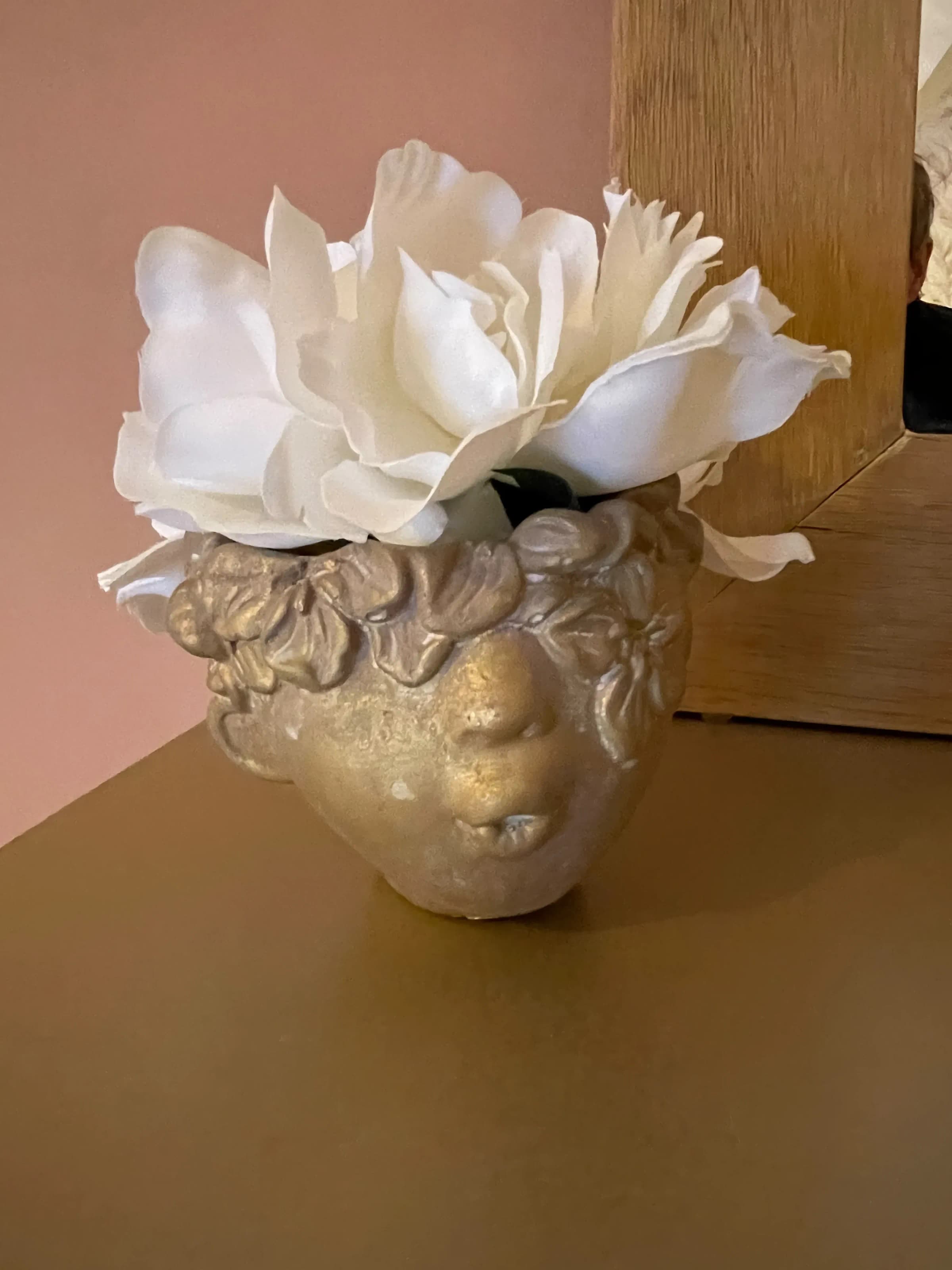 Decor detail, golden face vase