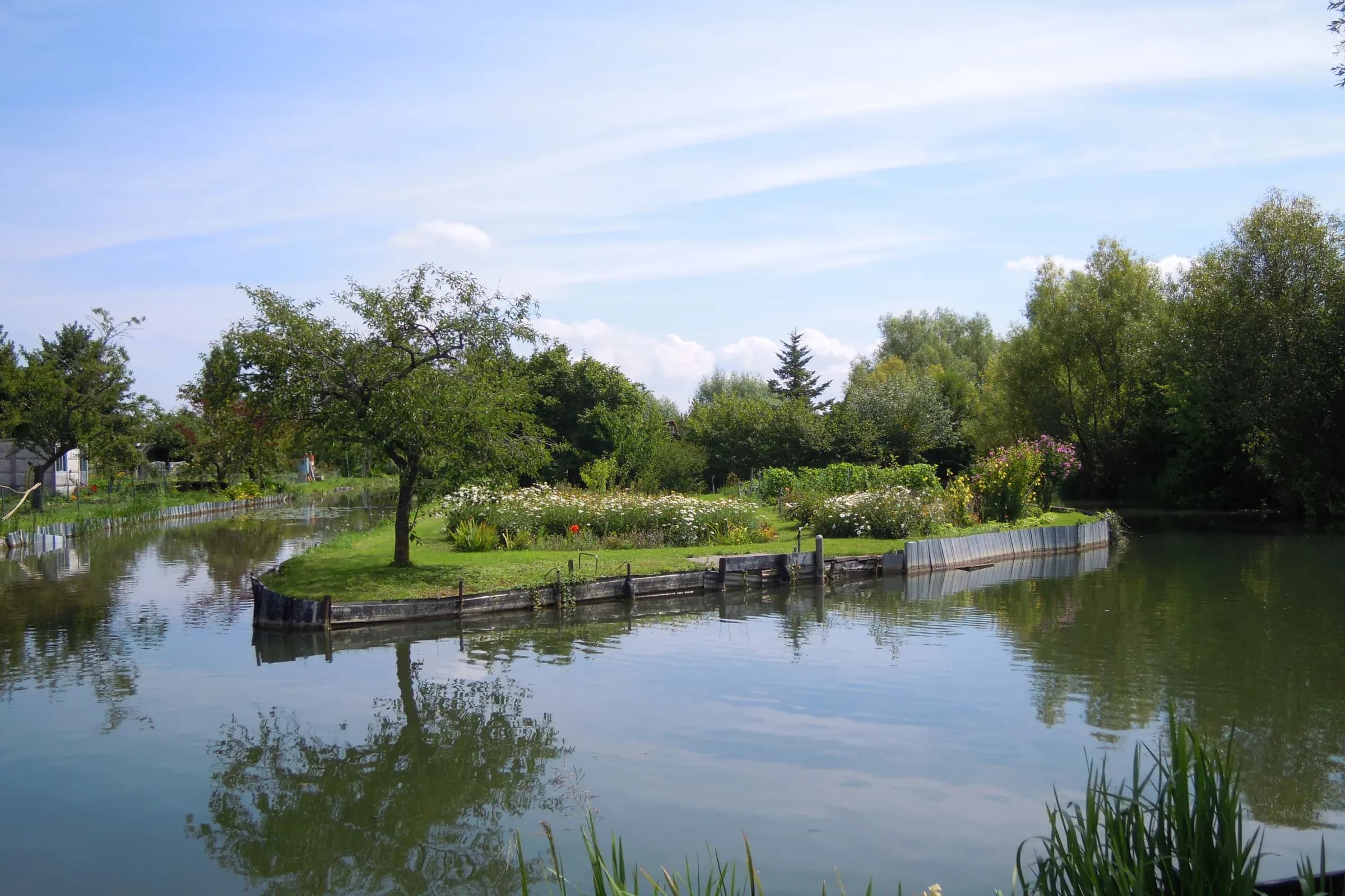 Garden on an island surrounded by water in the Bourges marshes in summer