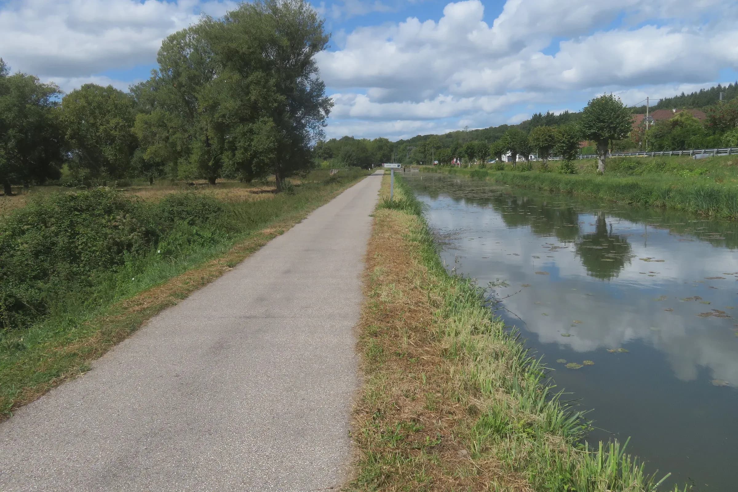 Greenway along the Berry canal at Mennetou-sur-Cher, clouds mirrored in the water
